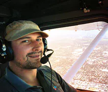 Eric flying a plan wearing a head set radio